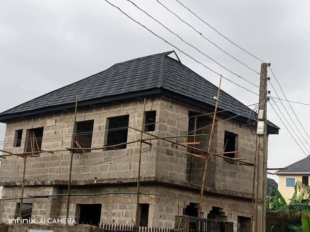 Two-storey building roofed with black stone-coated tiles