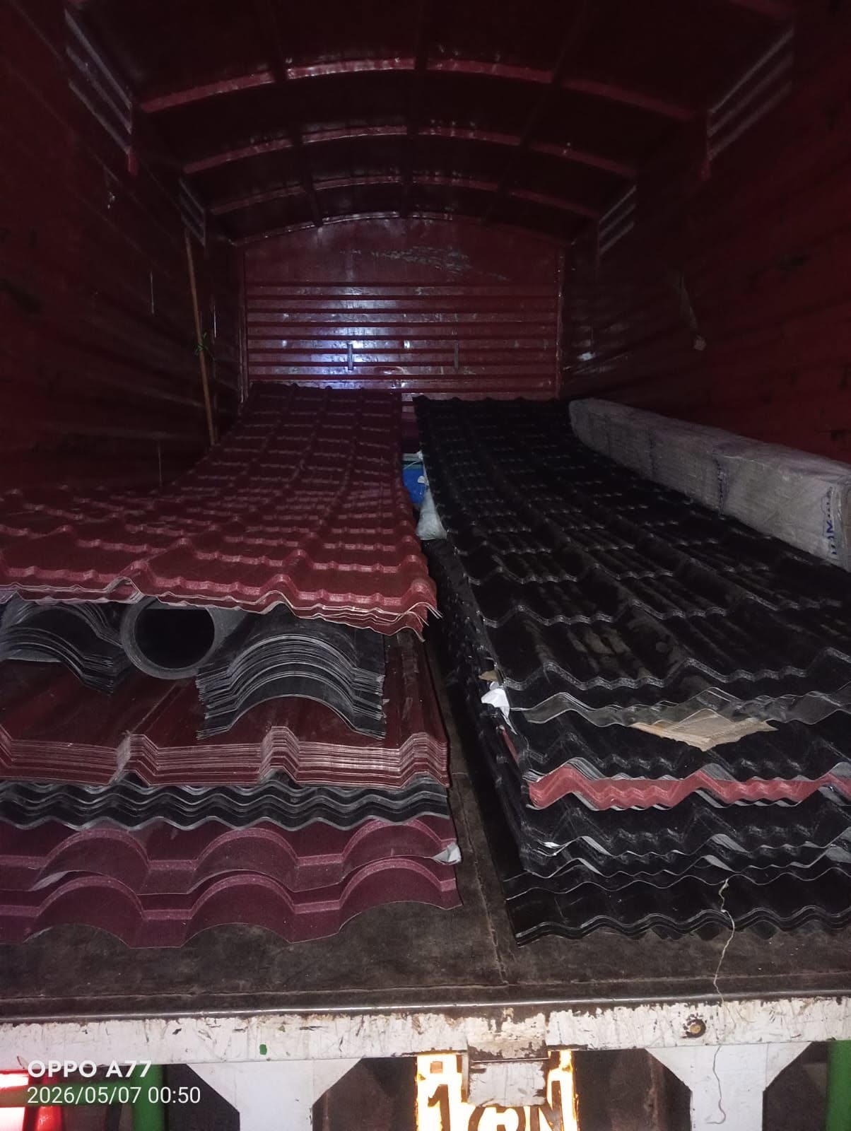 Maroon and black stone-coated roofing tiles loaded for nationwide delivery