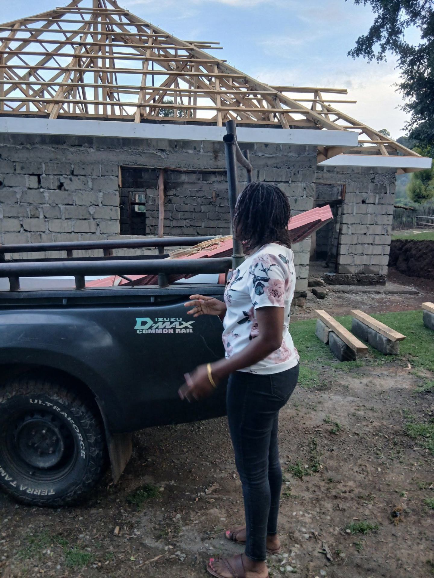 Customer receiving roofing sheets at a construction site