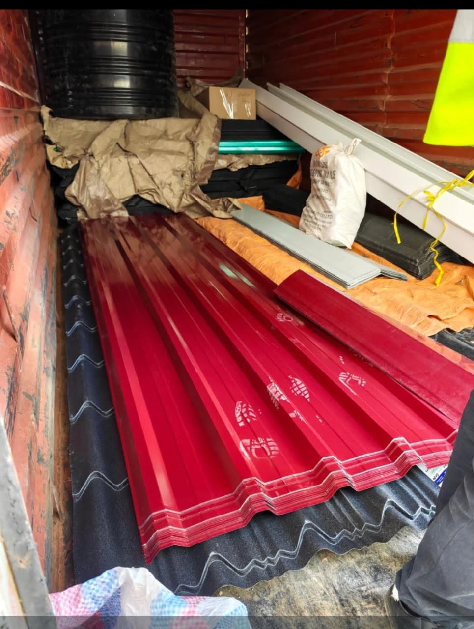 Maroon red box-profile mabati loaded inside a delivery truck